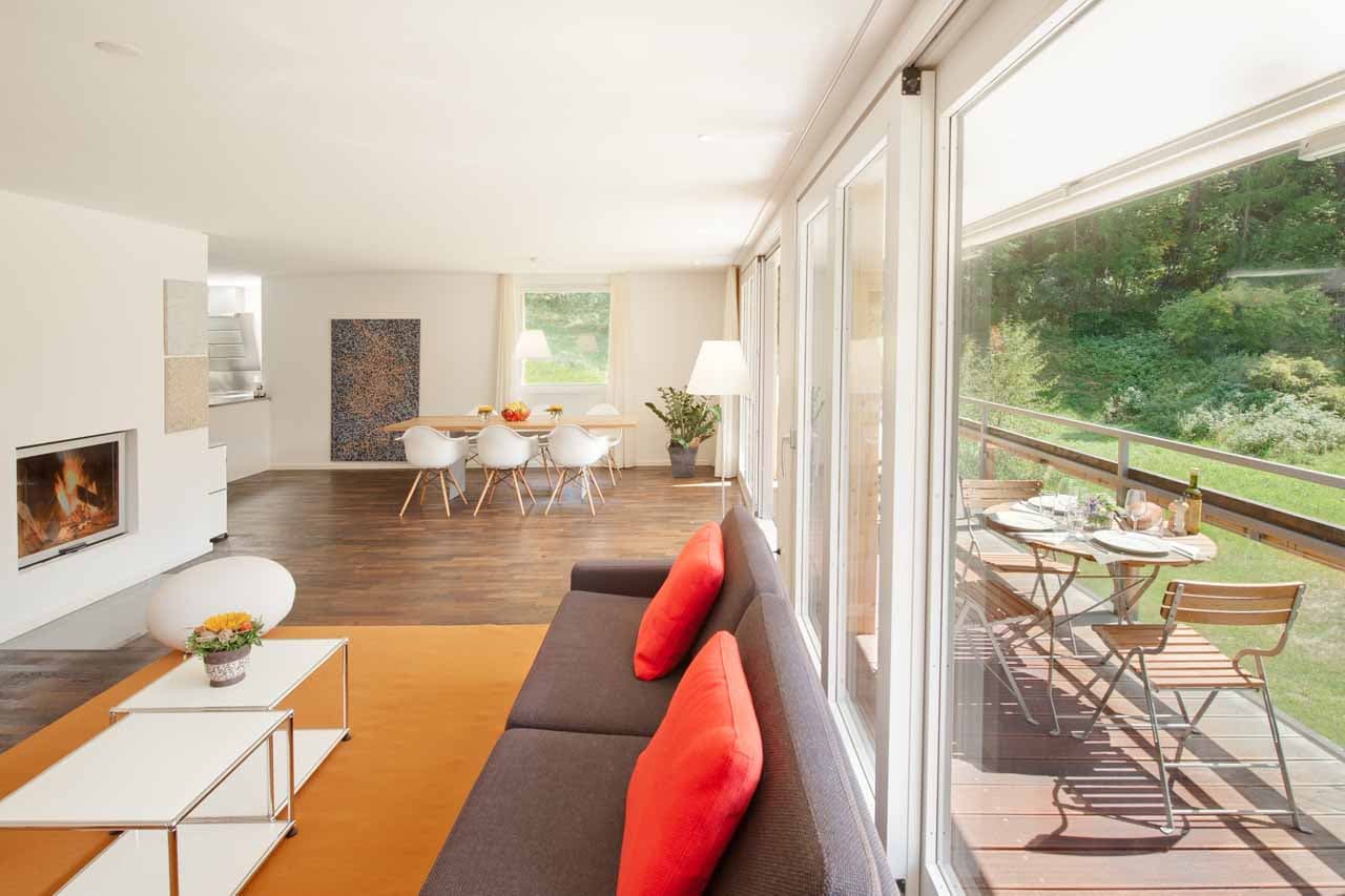 Open-plan living area with fireplace at Apartment Altesse 2 in Zermatt in summer